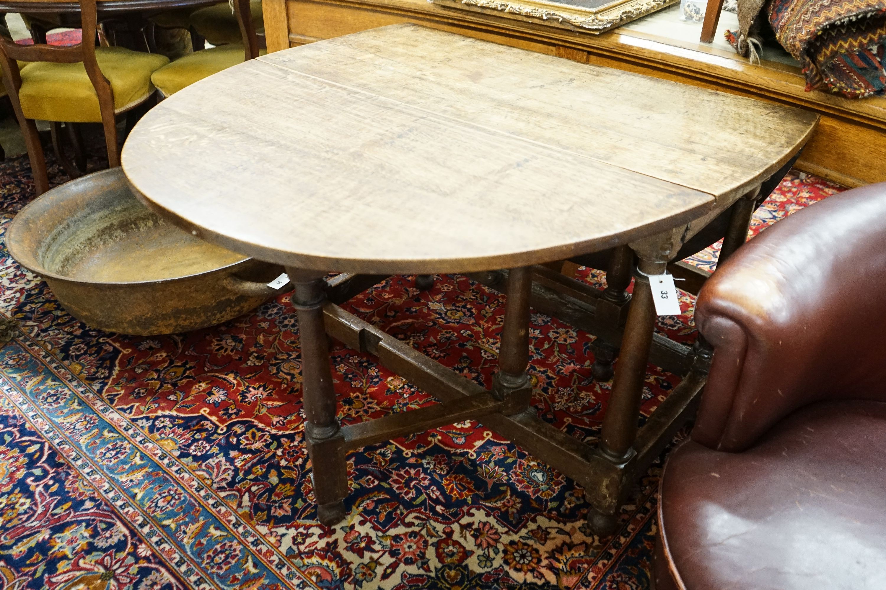 An 18th century style oak gateleg dining table, length 148cm extended, width 105cm, height 76cm